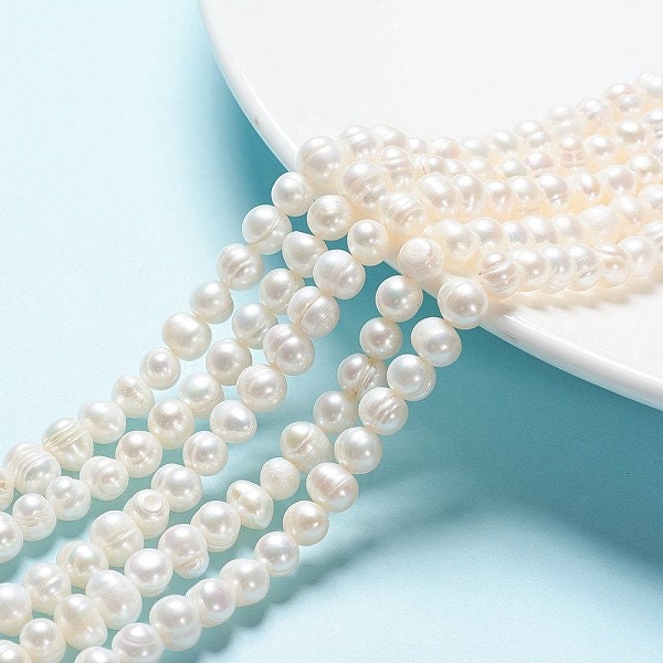 52 x grade A natural cultured freshwater pearls, potato, white, approximately 6-7mm, drilled, hole approximately 0.8mm