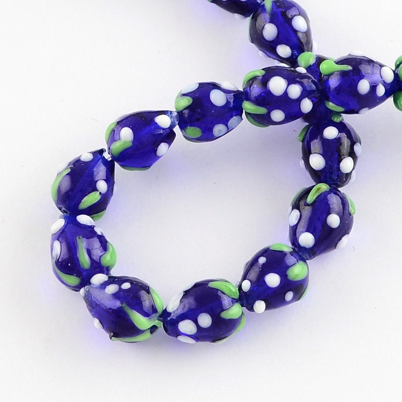 10 x handmade strawberry glass lampwork beads, dark blue with white & green decoration, approximately 16mm x 11mm, drilled 2mm hole