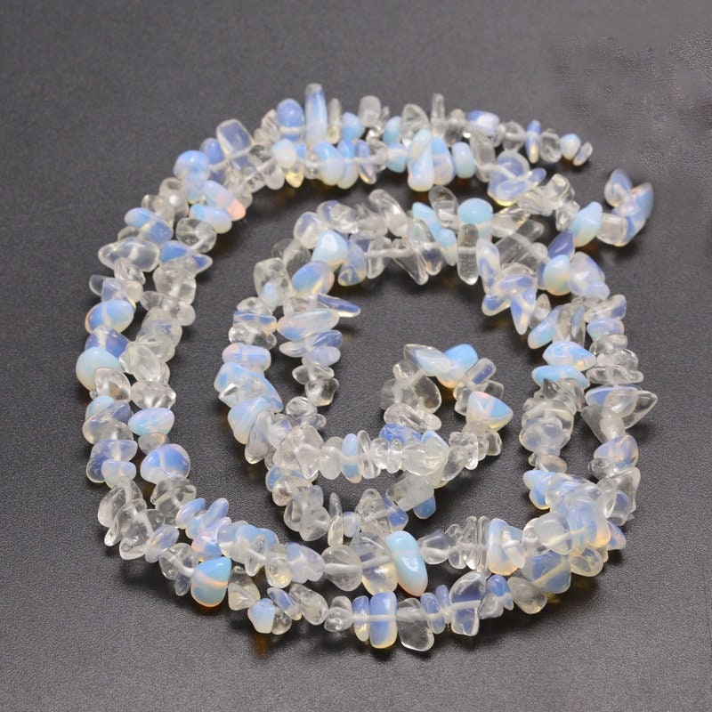 Approx 230 opalite chip beads, similar appearance to moonstone, 5~8x5~8mm, drilled with 1mm hole (approx), strand approximately 31.5 inches