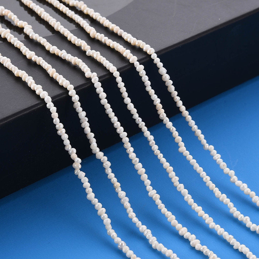 Approx 130 tiny natural cultured freshwater seed pearls, seashell colour, approximately 1.5mm x 1.5mm, drilled, hole approximately 0.5mm
