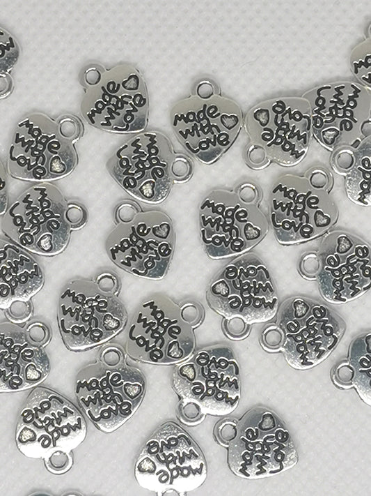 Heart shaped small pendants / tags, antique silver colour, stamped "made with love", approx 10mm wide, 12.2mm high, 1.8mm thick, hole: 2mm