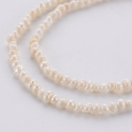 Approx 130 tiny natural cultured freshwater seed pearls, seashell colour, approximately 1.5mm x 1.5mm, drilled, hole approximately 0.5mm