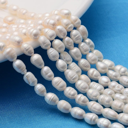 27 x grade A natural cultured freshwater pearls, white, rice shape, approximately 5.5-7mm x 4-5mm, drilled, hole approximately 0.8mm